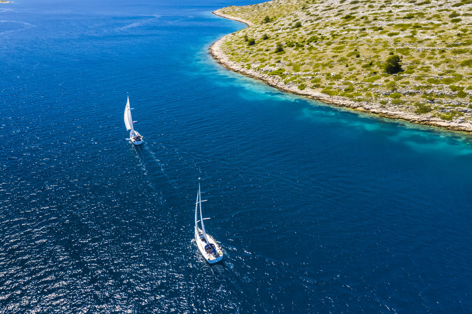 Sailing yacht with full sails in open sea